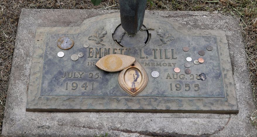 FILE - In this Aug. 28, 2015 file photo, the grave marker of Emmett Till has a photo of Till and coins placed on it during a gravesite ceremony at the Burr Oak Cemetery marking the 60th anniversary of the murder of Till in Mississippi, in Alsip, Ill. The woman at the center of the trial of Emmett Till's alleged killers has acknowledged that she falsely testified he made physical and verbal threats, according to a new book. Historian Timothy B. Tyson told The Associated Press on Saturday, Jan. 28, 2017, that Carolyn Donham broke her long public silence in an interview with him in 2008. (AP Photo/Charles Rex Arbogast)
