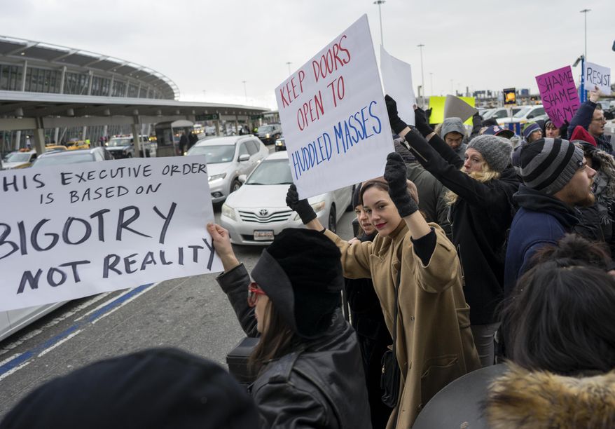 Protesters assemble at John F. Kennedy International Airport in New York, Saturday, Jan. 28, 2017 after two Iraqi refugees were detained while trying to enter the country. On Friday, Jan. 27, President Donald Trump signed an executive order suspending all immigration from countries with terrorism concerns for 90 days. Countries included in the ban are Iraq, Syria, Iran, Sudan, Libya, Somalia and Yemen, which are all Muslim-majority nations. (AP Photo/Craig Ruttle)