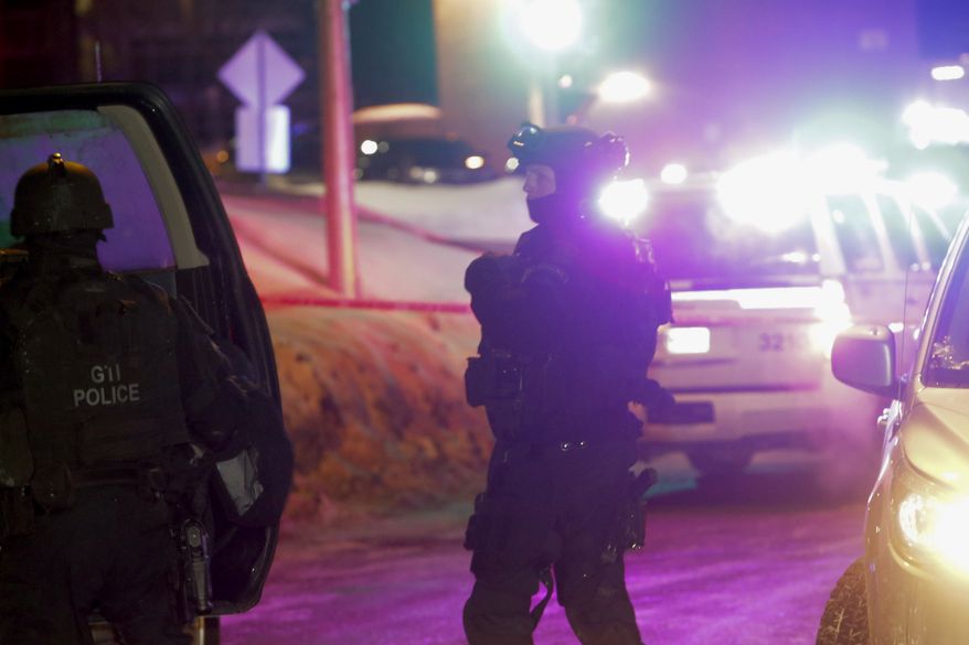 Police survey the scene after a deadly shooting at a mosque in Quebec City, Canada, Sunday, Jan. 29, 2017. Quebec Premier Philippe Couillard termed the act "barbaric violence" and expressed solidarity with victims' families. (Francis Vachon/The Canadian Press via AP)