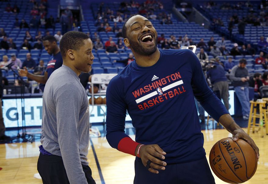 New Orleans Pelicans guard Tim Frazier, left, and Washington Wizards guard John Wall laugh together before an NBA basketball game in New Orleans, Sunday, Jan. 29, 2017. (AP Photo/Max Becherer)