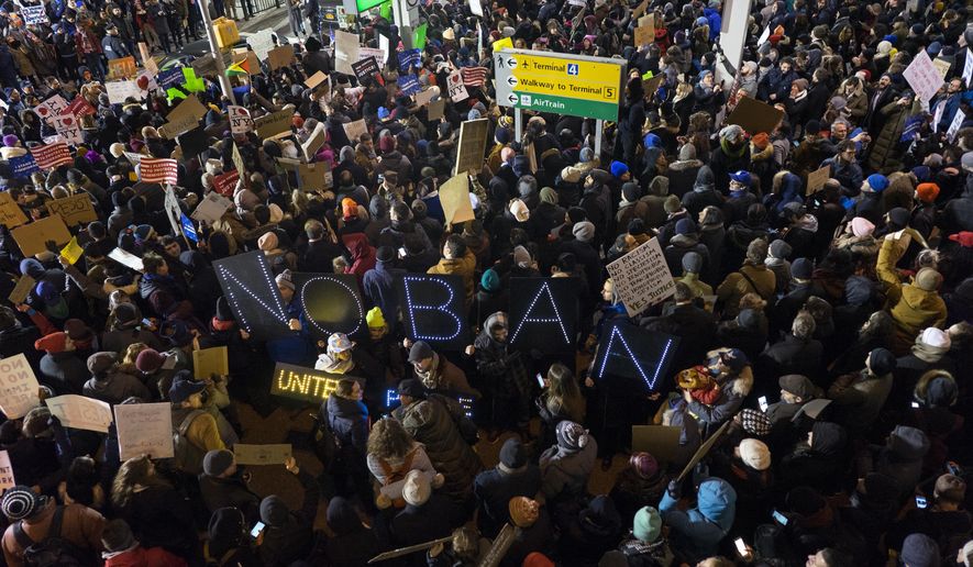 Protesters assemble at John F. Kennedy International Airport in New York, Saturday, Jan. 28, 2017, after earlier in the day two Iraqi refugees were detained while trying to enter the country. On Friday, Jan. 27, President Donald Trump signed an executive order suspending all immigration from countries with terrorism concerns for 90 days. Countries included in the ban are Iraq, Syria, Iran, Sudan, Libya, Somalia and Yemen, which are all Muslim-majority nations. (AP Photo/Craig Ruttle)
