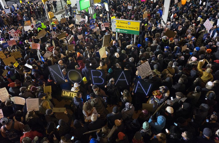 Protesters assemble at John F. Kennedy International Airport in New York, Saturday, Jan. 28, 2017, after earlier in the day two Iraqi refugees were detained while trying to enter the country. On Friday, Jan. 27, President Donald Trump signed an executive order suspending all immigration from countries with terrorism concerns for 90 days. Countries included in the ban are Iraq, Syria, Iran, Sudan, Libya, Somalia and Yemen, which are all Muslim-majority nations. (AP Photo/Craig Ruttle)