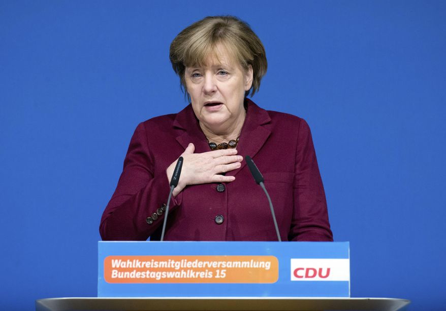 German Chancellor Angela Merkel delivers a speech at a local meeting of her Christian Democrats, CDU, in Grimmen, northern Germany, Saturday, Jan. 28, 2017. Merkel said there&#x27;s no solution yet to the problem of how to fairly share the burden of migration among European Union member states. (Stefan Sauer/dpa via AP)