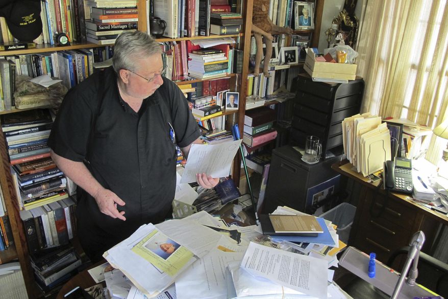 In this Dec. 15, 2016 photo, John Gillespie of San Sebastian Catholic Church in St. Augustine, Fla., reads a letter written by his slain colleague, Father Rene Robert. Last summer, after a multi-state manhunt that started in Florida and stretched to South Carolina, police arrested Steven Murray in connection with the 71-year-old Robert's killing. Murray led authorities into the Georgia woods, where Robert's body lay. Police said Murray had asked Father Rene for a ride, then kidnapped and fatally shot him. Prosecutors plan to seek the death penalty, a decision that Catholic officials from Georgia and Florida plan to protest on the courthouse steps. (AP Photo/Jason Dearen)