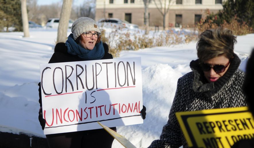 FILE - In this Jan. 10, 2017, file photo, Pierre, S.D., resident Roxanne Weber rallies in support of a voter-approved government ethics overhaul in front of the state Capitol in Pierre. Claiming South Dakotans were deceived by a misleading campaign for the ballot measure, Republicans are nearly finished dismantling the new regulations voters imposed upon them. (AP Photo/James Nord, File)