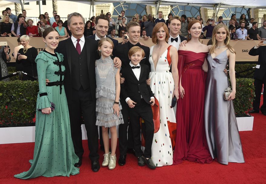 The cast of "Captain Fantastic," from left, Samantha Isler, Viggo Mortensen, writer-director Matt Ross, Shree Crooks, Nicholas Hamilton, Charlie Shotwell, foreground, Trin Miller, George MacKay, Annalise Basso, and Erin Moriarty arrive at the 23rd annual Screen Actors Guild Awards at the Shrine Auditorium & Expo Hall on Sunday, Jan. 29, 2017, in Los Angeles. (Photo by Jordan Strauss/Invision/AP)