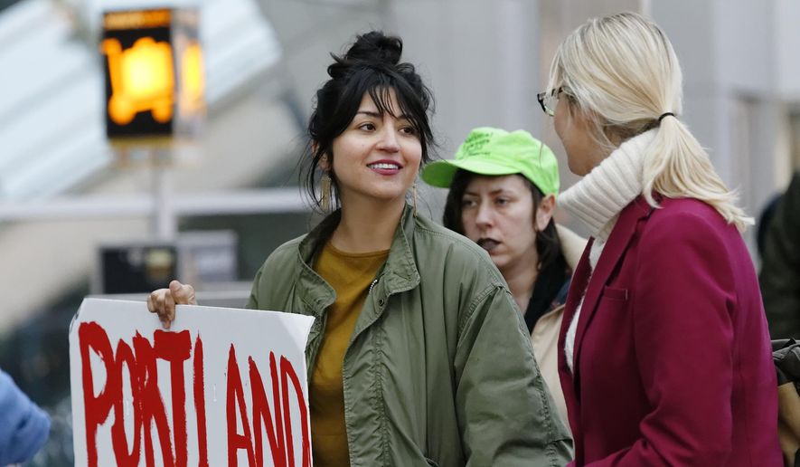 Lucia Martinez, who organized the rally, marches with others demonstrating in and around the main terminal at Portland International Airport, Saturday, Jan. 28, 2017, in Portland, Ore., to protest President Donald Trump&#39;s executive order barring nationals of seven Muslim-majority countries from entering the U.S.  (Mike Zacchino/The Oregonian via AP)