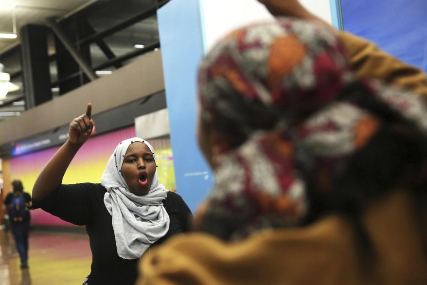 More than 1,000 people gather at Seattle-Tacoma International Airport to protest President Donald Trump's order that restricts immigration to the U.S., Saturday, Jan. 28, 2017., in Seattle. President Trump signed an executive order Friday that bans legal U.S. residents and visa-holders from seven Muslim-majority nations from entering the U.S. for 90 days and puts an indefinite hold on a program resettling Syrian refugees. (Genna Martin/seattlepi.com via AP)