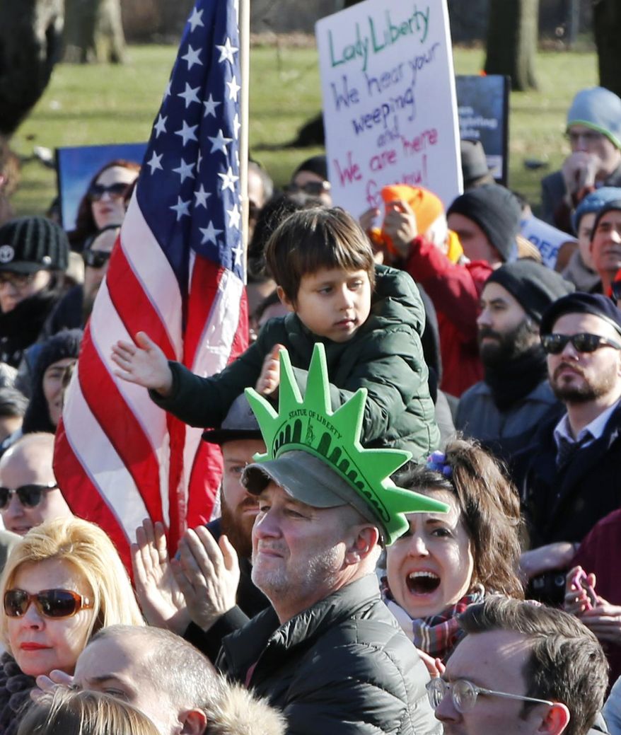 Protesters of all ages participate in an immigrants' rights' rally at Battery Park's Castle Clinton National Monument, Sunday, Jan. 29, 2017, in New York. President Donald Trump's immigration order sowed more chaos and outrage across the country Sunday, with travelers detained at airports, panicked families searching for relatives while protesters like these registered their opposition to the sweeping measure that was blocked by several federal courts. (AP Photo/Kathy Willens)