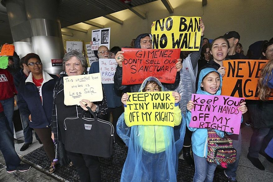 Protesters rally against President Trump's refugee ban at Miami International Airport on Sunday, Jan. 29, 2017.b President Donald Trump’s immigration order sowed more confusion and outrage across the country Sunday, with travelers detained at airports, panicked families searching for relatives and protesters registering their opposition to the sweeping measure. (C.M. Guerrero/El Nuevo Herald via AP)