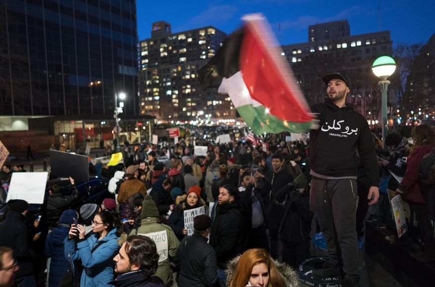 People gather in New York's Foley Square, Sunday, Jan. 29, 2017, as they protest against President Donald Trump's executive order banning travel to the U.S. by citizens of several countries. (AP Photo/Craig Ruttle)