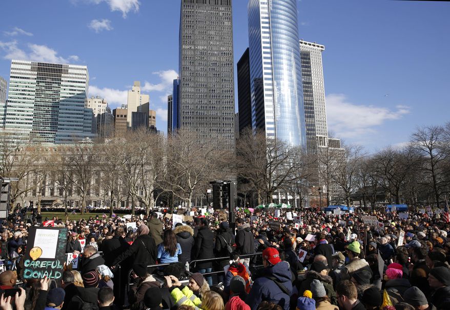 A large crowd of immigrants' rights advocates gather in Battery Park, Sunday, Jan. 29, 2017, in New York, as President Donald Trump's immigration order sowed more chaos and outrage across the country. These protesters registered their opposition to the president's sweeping measure that was blocked by several federal courts. (AP Photo/Kathy Willens)