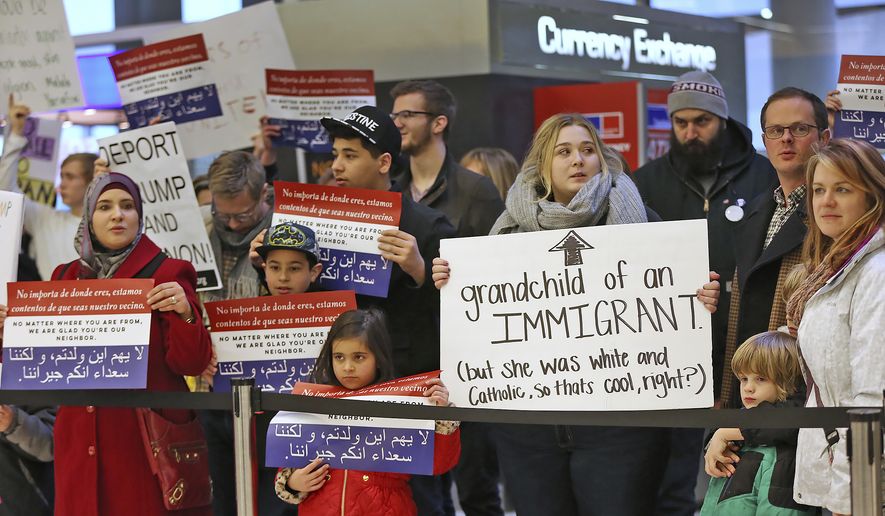 People chant slogans at the Indianapolis International Airport, Sunday, Jan. 29, 2017, during a protest against President Donald Trump&#39;s executive order temporarily suspending all immigration for citizens of seven majority Muslim countries for 90 days. (Kelly Wilkinson/The Indianapolis Star via AP)