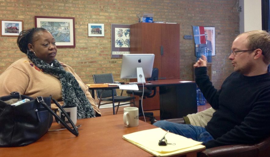 HOLD FOR STORY BY SARA BURNETT - In this Dec. 22, 2016 photo, Lavette Mayes talks with Max Suchan who co-founded the Chicago Community Bond Fund in Chicago. Mayes, was arrested for the first time after she got into a fight with her mother-in-law, spent more than a year in Cook County Jail unable to come up with $25,000 needed to post bond. The mother of two, said she "lost everything before the CCBF got her out. Mayes resolved her aggravated battery case a few months after she got out and was sentenced to one day in prison, with credit for the 571 days already served. (AP Photo by Sara Burnett)