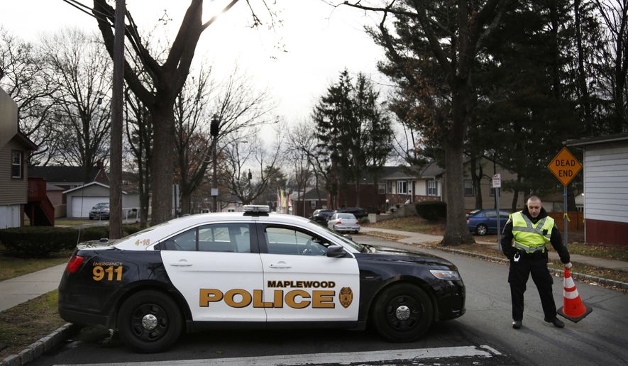 A police officers blocks the entrance to Van Ness Court in Maplewood, N.J., Monday, Jan. 30, 2017, the day after three people were found dead in an apartment there. Police are investigating their deaths as a homicide. (AP Photo/Seth Wenig)