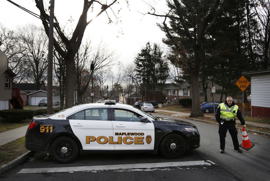 A police officers blocks the entrance to Van Ness Court in Maplewood, N.J., Monday, Jan. 30, 2017, the day after three people were found dead in an apartment there. Police are investigating their deaths as a homicide. (AP Photo/Seth Wenig)