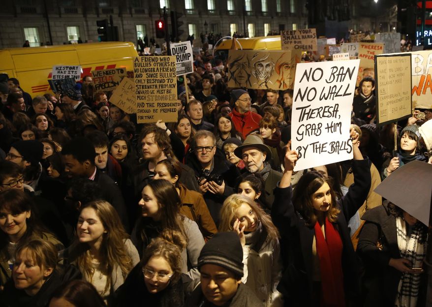Demonstrators hold banners during a protest against U.S President Donald Trump's controversial travel ban on refugees and people from seven mainly-Muslim countries, outside Downing Street in London, Monday, Jan. 30, 2017. On Friday President Trump signed an executive order halting the US refugee programme for 120 days, indefinitely banning all Syrian refugees and suspended issuing visas for people from Iran, Iraq, Libya, Somalia, Sudan, Syria or Yemen for at least 90 days. (AP Photo/Alastair Grant)