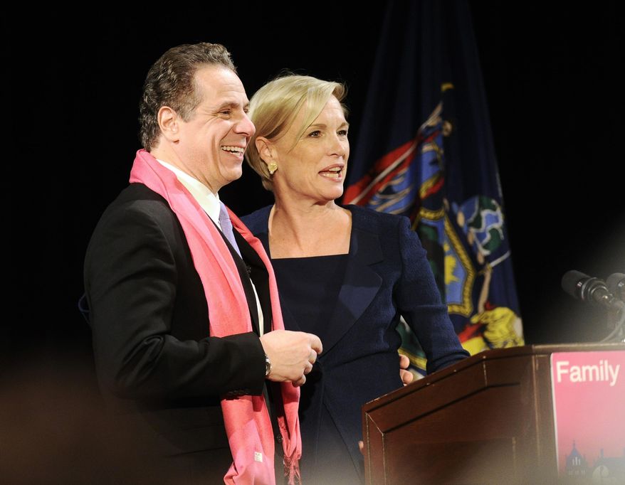 New York Gov. Andrew Cuomo, left, is introduced by Cecile Richards President of the Planned Parenthood Federation of America before delivering his remarks during the Family Planning Advocates' 2017 Day of Action Rally on Monday, Jan. 30, 2017, in Albany, N.Y. Cuomo called for a state constitutional amendment guaranteeing women the right to legal abortions Monday, saying the state must work to push back against President Donald Trump and other Washington Republicans who have worried supporters of Roe v. Wade, the landmark 1973 Supreme Court decision that legalized abortion nationwide. (AP Photo/Hans Pennink)