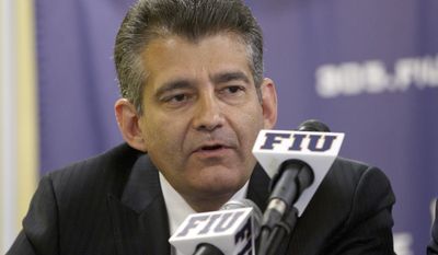 FILE - In this April 16, 2012, file photo, Florida International Vice President Pete Garcia talks to the media during a press conference in Miami, where it was announced that Richard Pitino had been hired to replace Isiah Thomas as head men's basketball coach. FIU football head coach Butch Davis and FIU director of sports and entertainment Garcia have been joined at the hip for much of their football lives, and are again now. Davis' first class of FIU recruits will be unveiled Wednesday, Feb. 1, 2017, and he got plenty of help from Garcia in putting it together, just like at Miami two decades ago when they lured star after star after star to the Hurricanes. (AP Photo/J Pat Carter, File)