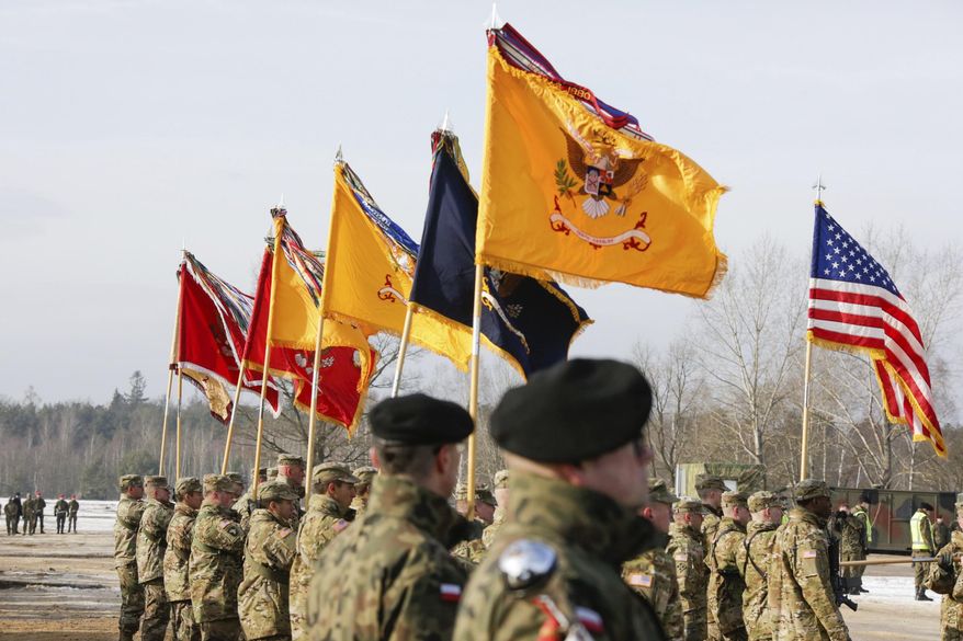 U.S. Army and Polish Army soldiers attend a ceremony opening their exercise on training fields in Zagan, Poland, Monday, Jan. 30, 2017. (AP Photo/Krzysztof Zatycki)
