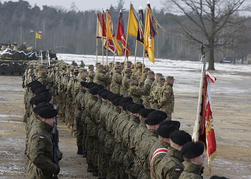 U.S. Army and Polish Army soldiers attend a ceremony opening their exercise on training fields in Zagan, Poland, Monday, Jan. 30, 2017. (AP Photo/Krzysztof Zatycki)