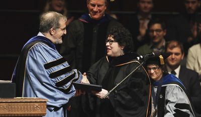 University of Michigan President Mark Schlissel presents Supreme Court Justice Sonia Sotomayor, a Doctor of Laws degree, Monday, Jan. 30, 2017, during a ceremony at the university in Ann Arbor, Mich. (AP Photo/Carlos Osorio)