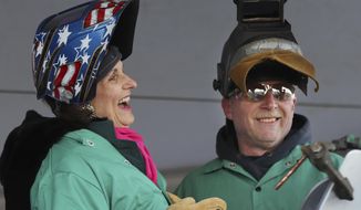 Lynda Johnson Robb, a daughter of the late President Lyndon B. Johnson, laughs after lifting her welding mask after assisting Bath Iron Works welder Timothy Trask at a keel-laying ceremony for the future USS Lyndon B. Johnson, Monday, Jan. 30, 2017, at Bath Iron Works in Bath, Maine. The ceremony marked the joining of two massive hull units, the first of several that will comprise the 610-foot Zumwalt class destroyer.(AP Photo/Robert F. Bukaty)