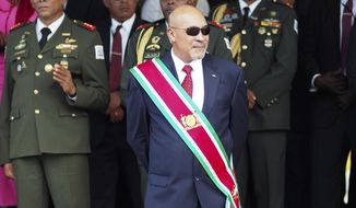 FILE - In this Aug. 12, 2015 file photo, Suriname President Desire Delano Bouterse observes a military parade, after being sworn in for his second term, in Paramaribo, Suriname. A military court in Suriname on Monday, Jan. 30, 2017, ordered the president to resume his long-stalled murder trial in the killing of political opponents under his dictatorship in 1982. (AP Photo/Ertugrul Kilic, File)