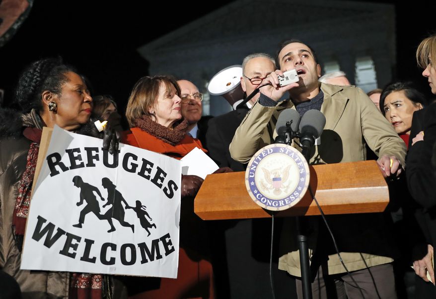 Omar al-Muqdad, from Syria, speaks with Rep. Sheila Jackson Lee D-Texas, left, House Minority Leader Nancy Pelosi of Calif., and Senate Minority Leader Chuck Schumer of New York, and other members of Congress nearby in front of the Supreme Court about President Donald Trump's recent executive orders, Monday, Jan. 30, 2017 in Washington. (AP Photo/Alex Brandon)