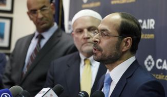 Council on American-Islamic Relations (CAIR) National Executive Director Nihad Awad, right, speaks as attorney Shereef Akeel, left, and CAIR national communications director Ibrahim Hooper stand nearby, during a news conference at the Council on American-Islamic Relations (CAIR), Monday, Jan. 30, 2017, in Washington. The group announced the filing of a federal lawsuit on behalf of more than 20 individuals challenging an executive order signed by President Donald Trump. (AP Photo/Alex Brandon)  ** FILE **