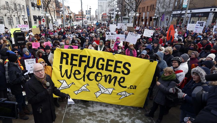 Thousands of people protest against the U.S. immigration policy of U.S. President Donald Trump, at the United States embassy in Ottawa, Monday, Jan. 30, 2017. (Fred Chartrand/The Canadian Press via AP)