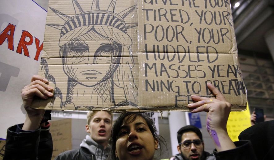 Demonstrators converge outside Terminal 5 of O'Hare International Airport, Sunday, Jan. 29, 2017, in Chicago, as people protest President Donald Trump's executive order banning travel to the United States by citizens of several countries. (AP Photo/Nam Y. Huh)