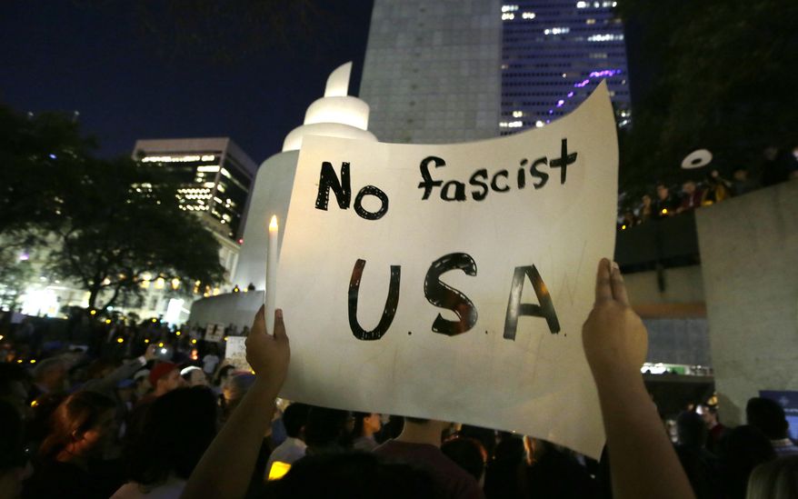 People participate in a candlelight vigil at Thanksgiving Square in downtown Dallas, Monday, Jan. 30, 2017. People gathered to protest against President Donald Trump's executive order temporarily banning immigrants from seven Muslim-majority countries from entering the U.S. and suspending the nation’s refugee program. (AP Photo/LM Otero)