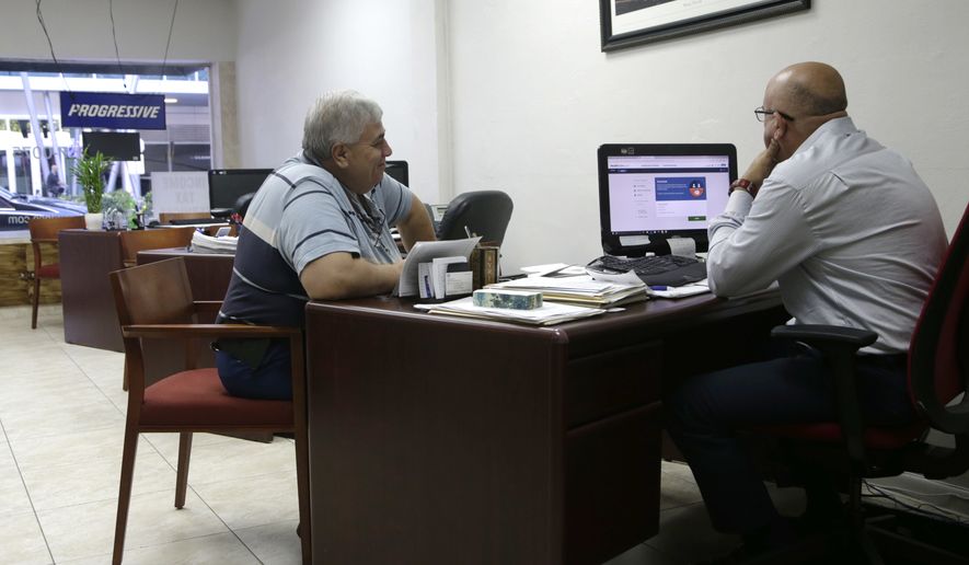 Sami Jamaleddine, left, signs up for health insurance offered under the Affordable Care Act with insurance agent Michael Khoury, right, Tuesday, Jan. 31, 2017, in Miami. The enrollment period for the federal health care law known as &quot;Obamacare&quot; ends at the end of the day Tuesday. The Republican-lead Senate has passed a measure to take the first step forward on dismantling President Barack Obama&#39;s health care law. (AP Photo/Lynne Sladky)