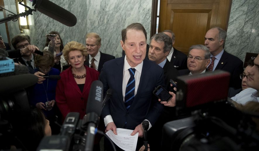 Sen. Ron Wyden, D-Ore., ranking member of the Senate Finance Committee, center, accompanied by, from left, Sen. Debbie Stabenow, D-Mich., Sen. Bill Nelson, D-Fla., Sen. Sherrod Brown, D-Ohio, Sen. Robert Menendez, D-N.Y. and Sen. Bob Casey, D-Pa., speaks in the hallway on Capitol Hill in Washington, Tuesday, Jan. 31, 2017, to discuss opposition to Human Services Secretary-designate, Rep. Tom Price, R-Ga. (AP Photo/Andrew Harnik) **FILE**