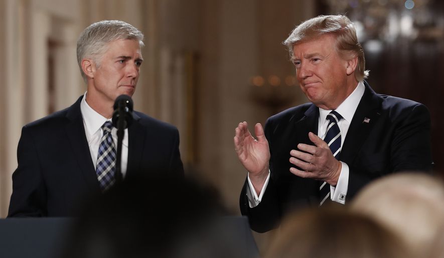 President Donald Trump applauds as he stands with Judge Neil Gorsuch in East Room of the White House in Washington, Tuesday, Jan. 31, 2017, after announcing Gorsuch as his nominee for the Supreme Court. (AP Photo/Carolyn Kaster)