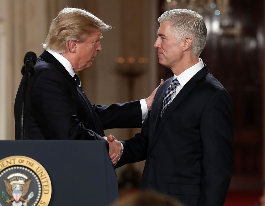 President Donald Trump shakes hands with 10th U.S. Circuit Court of Appeals Judge Neil Gorsuch, his choice for Supreme Court Justices in the East Room of the White House in Washington, Tuesday, Jan. 31, 2017. (AP Photo/Carolyn Kaster)