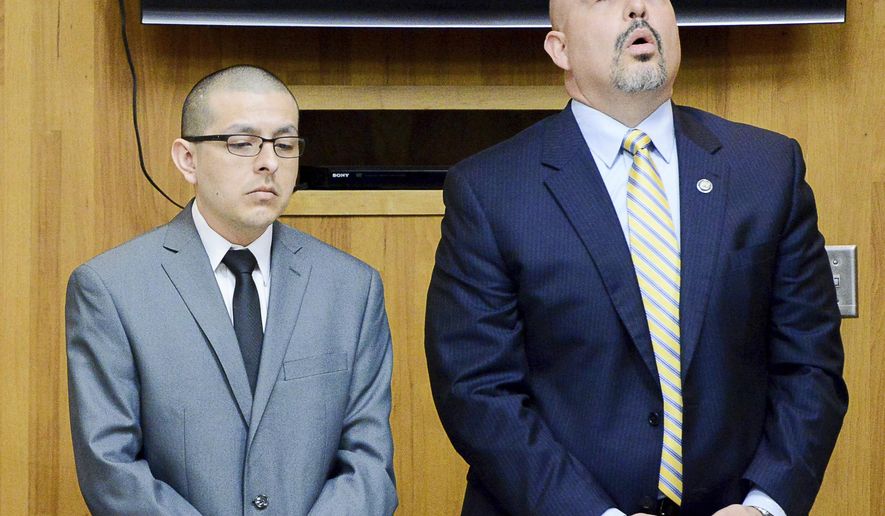 Attorney Carlos Garcia, right, reacts to the reading of a not guilty verdict on murder charges against his client, former U.S. Border Patrol agent Joel Luna, on Tuesday, Jan. 31, 2017, in the 107th state District Courtroom in Brownsville, Texas. Luna was found guilty on charges of engaging in organized criminal activity while his brother Eduardo Luna was found guilty of all charges, sentenced to life without parole. (Jason Hoekema/The Brownsville Herald via AP)