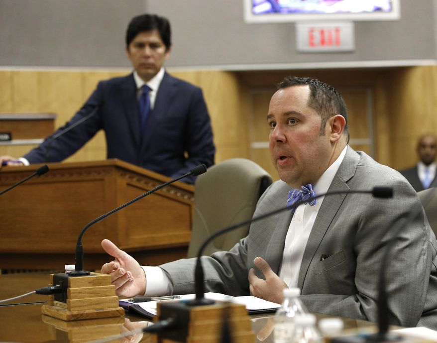 Cory Salzillo, right, representing the California State's Sheriff's Association, discusses his groups opposition to a proposed bill to prohibit local law enforcement from cooperating with federal immigration authorities, during a hearing of the Senate Public Safety Committee, Tuesday, Jan. 31, 2017, in Sacramento, Calif. The committee passed SB54, by Senate President Pro Tem Kevin de Leon, left, D-Los Angeles, that if approved by the Legislature and signed by the governor, could create a border-to-border sanctuary in the nation's largest state. (AP Photo/Rich Pedroncelli)