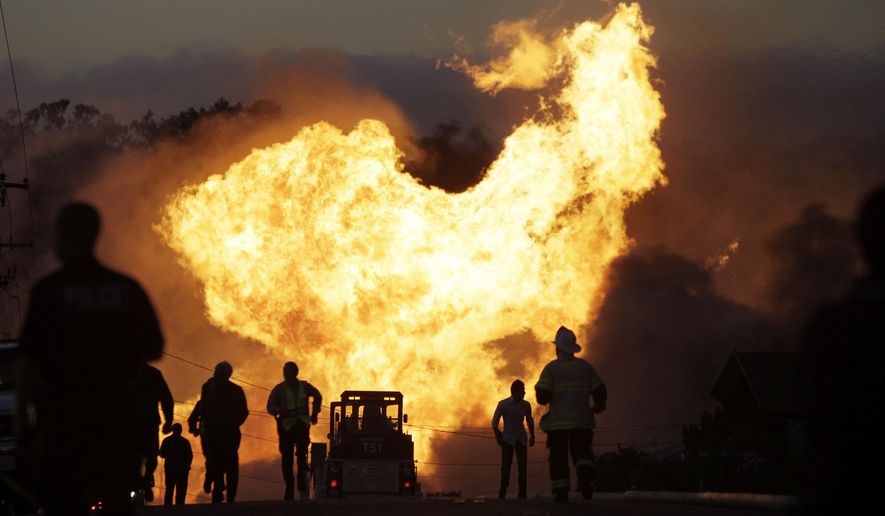 FILE - In this Sept. 9, 2010 file photo, a massive fire roars through a neighborhood in San Bruno, Calif. Pacific Gas & Electric Co. says it is prepared to pay the maximum fine of $3 million after a jury convicted the company of deliberately violating pipeline safety regulations before a deadly natural gas pipeline explosion in the San Francisco Bay Area and then misleading investigators looking into the blast. (AP Photo/Paul Sakuma, File)