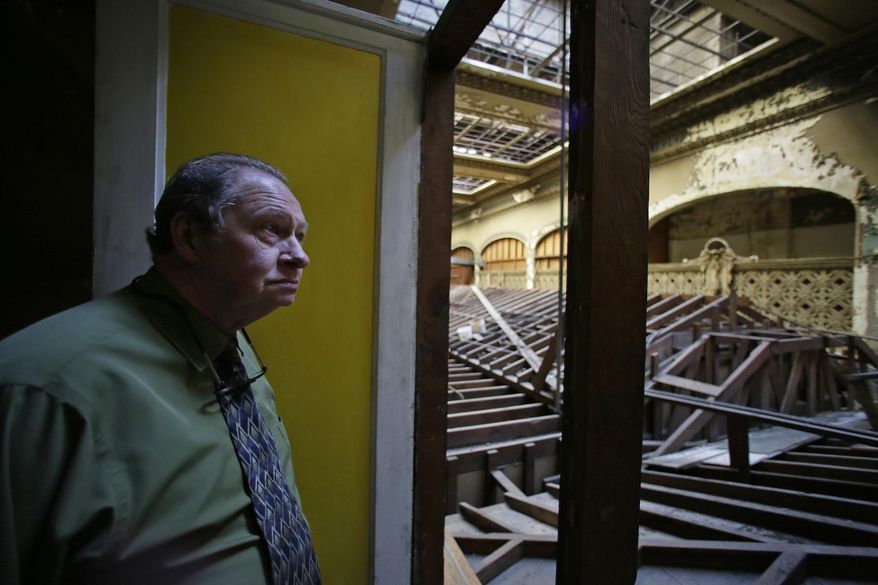 In this photo taken Friday, Jan. 13, 2017, manager John Fair looks out at the upper floor of the building that houses Lefty O'Doul's restaurant and lounge below in San Francisco. The historic baseball memorabilia and piano bar beloved by locals and tourists is set to close this week after its lease expires. Lefty O’Doul’s may return to downtown Union Square, but it's unclear who will be in charge as the bar's longtime operator and building owner are fighting over ownership. The establishment's final day is Wednesday, Feb. 1. (AP Photo/Eric Risberg)