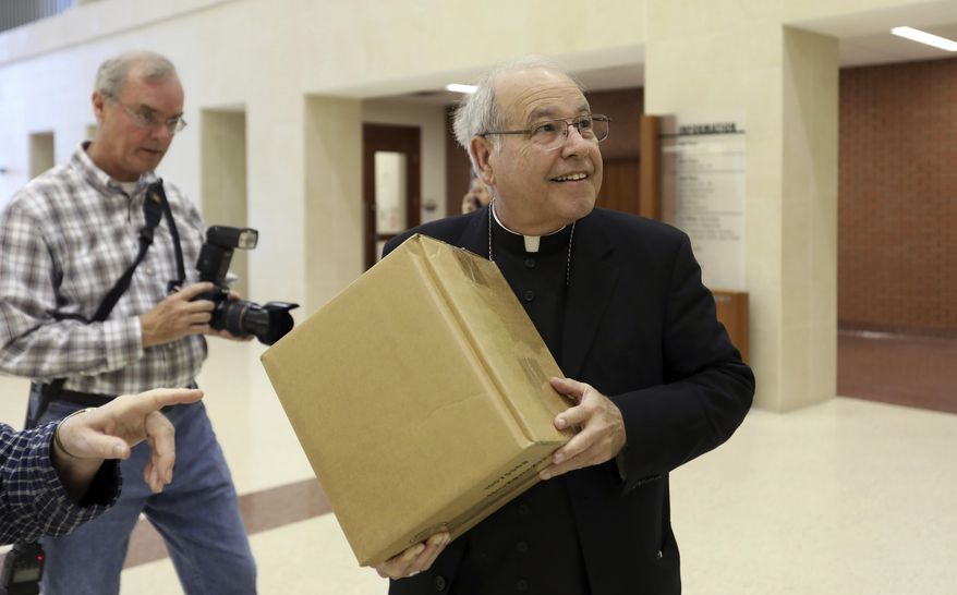 Bishop Felipe Estevez of the Diocese of St. Augustine delivers petitions to honor Father Rene Wayne Robert's "Declaration of Life" at the Richmond County Courthouse on Tuesday, Jan. 31, 2017, in Augusta, Ga. The Archbishop, along with bishops Felipe Estevez and Gregory Hartmayer gathered to ask the district attorney to not seek the death penalty in the case against Steven James Murray, who is accused of killing the Rev. Rene Robert. The bishops noted that Robert left a signed and notarized “Declaration of Life” saying that if he were to suffer a violent death he wouldn’t want the person responsible to be executed. (AP Photo/Heidi Heilbrunn)