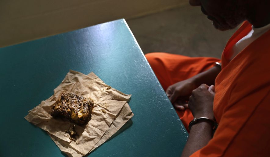 In this Oct. 26, 2016 photo, a nutraloaf, a meal typically given to inmates for misbehavior involving food or bodily waste, sits in front of inmate Kevin Dickens during an interview with The Associated Press at James T. Vaughn Correctional Center in Smyrna, Del. Dickens holds the dubious distinction of being on a loaf diet for longer than any other Delaware inmate -- five consecutive weeks in 2009. Originally sentenced to four years behind bars in 2002 for assault, has been convicted 18 times since then for assault in a detention facility. Without those additional 18 charges, he would have been released in 2006, but he is now looking at a release date of 2051. (AP Photo/Patrick Semansky)