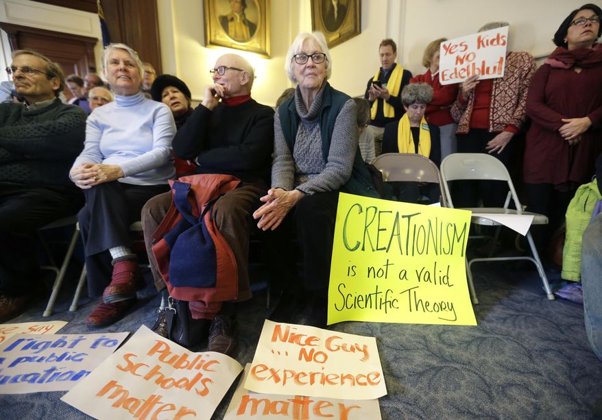 People with signs opposing Frank Edelblut, Gov. Chris Sununu&#39;s nominee to lead the state&#39;s education department, wait for a public hearing to begin, Tuesday, Jan. 31, 2017, at the Statehouse in Concord, N.H. (AP Photo/Elise Amendola)
