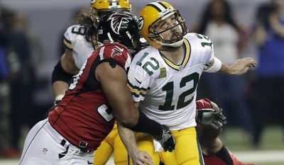 FILE - In this Jan. 22, 2017, file photo, Atlanta Falcons defensive end Dwight Freeney (93) hits Green Bay Packers' Aaron Rodgers after throwing a pass during the second half of the NFL football NFC championship game in Atlanta. Once the season is over, Freeney will think about his future. With his 37th birthday just weeks away, he knows time is running short. But if this is to be his final game, what a way to go out. (AP Photo/David J. Phillip, File)