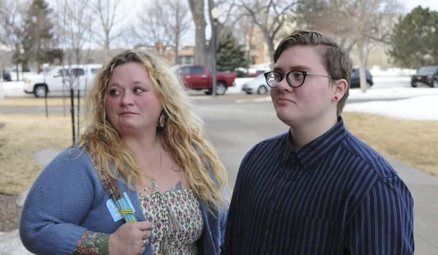 Jessie Lamphere, a transgender high school student, stands with his mom, Tyler Lamphere, left, after a brief hearing at the state Capitol in Pierre, S.D., Tuesday, Jan. 31, 2017. A bill that would have restricted which locker rooms South Dakota transgender students could use was withdrawn Tuesday. (AP Photo/James Nord)