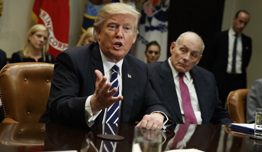 President Donald Trump, accompanied by Homeland Security Secretary John Kelly, right, speaks during a meeting on cyber security in the Roosevelt Room of the White House in Washington, Tuesday, Jan. 31, 2017. (AP Photo/Evan Vucci)