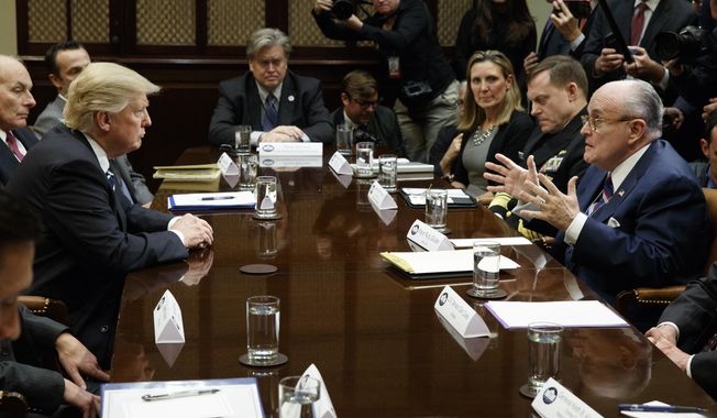 Former New York Mayor Rudy Giuliani, right, speaks to President Donald Trump during a meeting on cyber security in the Roosevelt Room of the White House in Washington, Tuesday, Jan. 31, 2017. (AP Photo/Evan Vucci) **FILE**