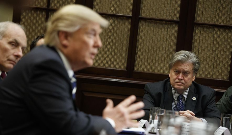 Then-White House chief strategist Stephen K. Bannon listens at right as President Donald Trump speaks during a meeting on cybersecurity in the Roosevelt Room of the White House in Washington, Tuesday, Jan. 31, 2017. (AP Photo/Evan Vucci) ** FILE **