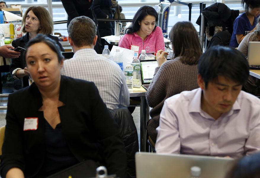 Volunteer lawyers work to help free travelers detained at John F. Kennedy International Airport in New York, Sunday, Jan. 29, 2017. As President Donald Trump’s order temporary banning refugees and citizens from seven Muslim-majority countries from traveling to the U.S.. dozens of attorneys descended on JFK., to advocate for people suddenly stuck in a limbo they argue is unjust and illegal. (AP Photo/Seth Wenig)